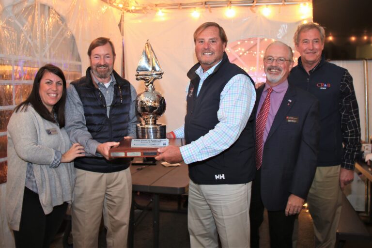 Christine Lasser of Hospice Cup stands with the winners of the 2021 Hospice Cup while they hold the Triple Crown of Charity Trophy. John Heinz of the Leukemia Cup and Paul Bollinger of CRAB