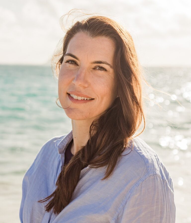 CRAB Director of Marketing and Development Rebecca Gonser standing if front of open water on a beautiful day