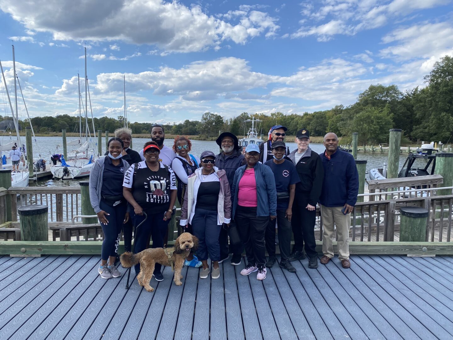 Group photo of CRAB guests and volunteers on dock from a CRAB clinic event. 