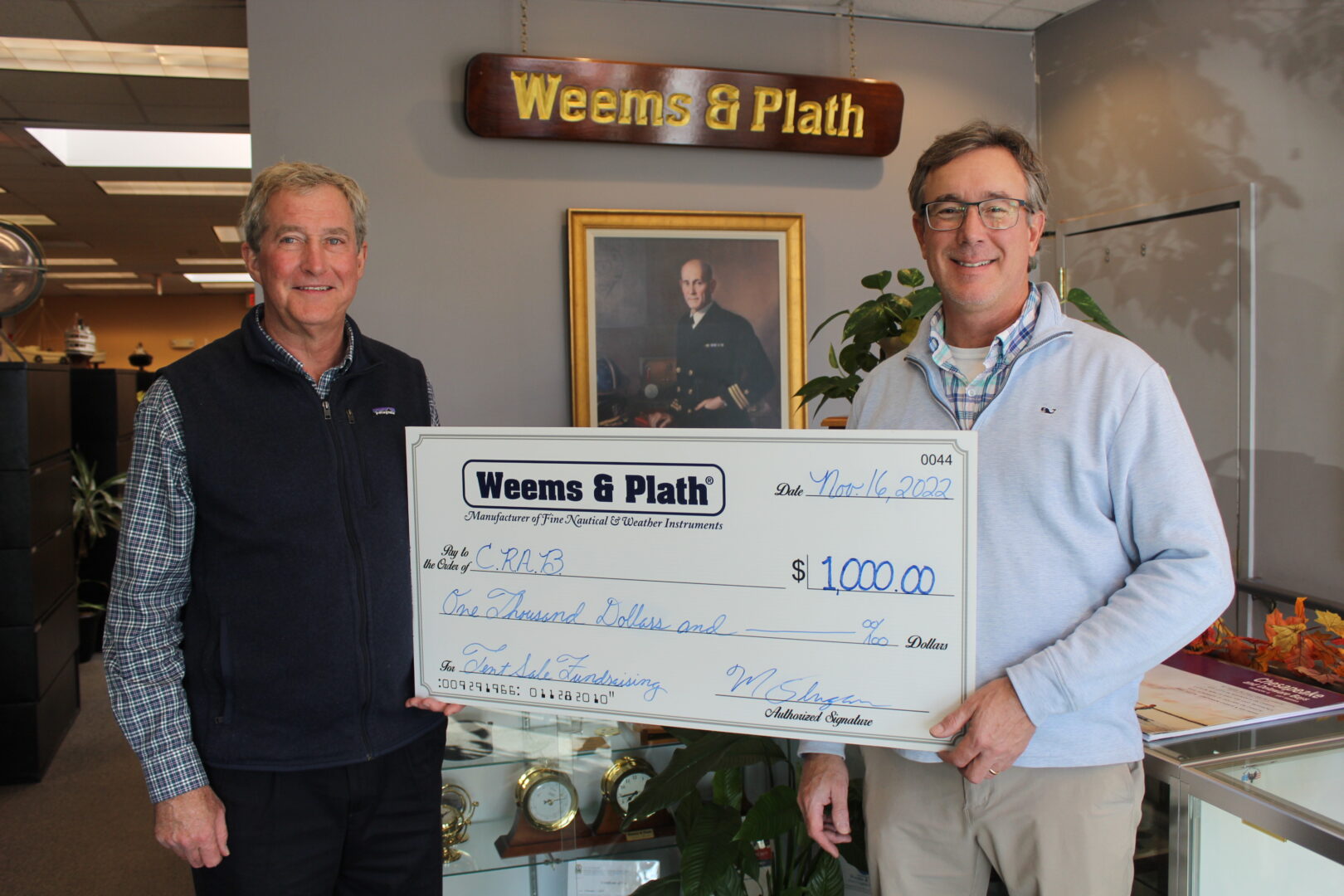 A photo of CRAB's Executive Director, Paul Bollinger, receiving a large check from a CRAB Sponsor, Weems and Plath. 
