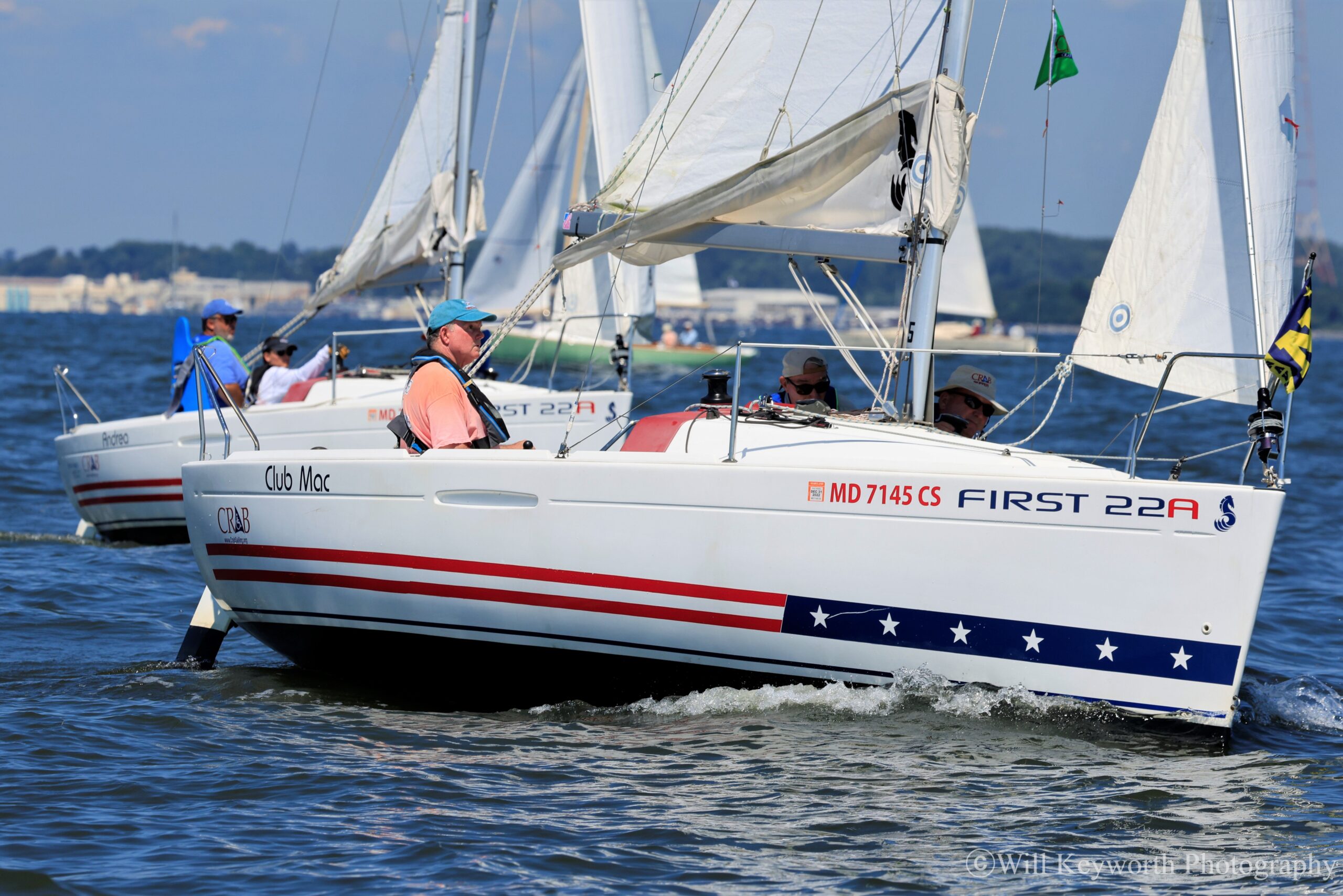 A photo of two of CRAB's 6 Beneteau First 22As (A for Adaptive) sailboats on the water. 