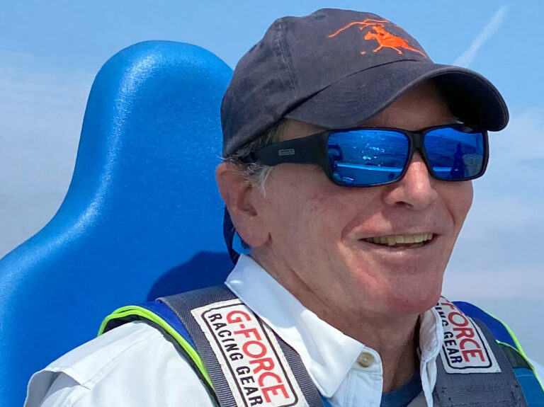 Photo of a guest smiling onboard a CRAB sailboat. 
